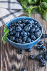 The patina of time on the weathered wood stands as a silent witness to the natural perfection of the fresh, juicy blueberries