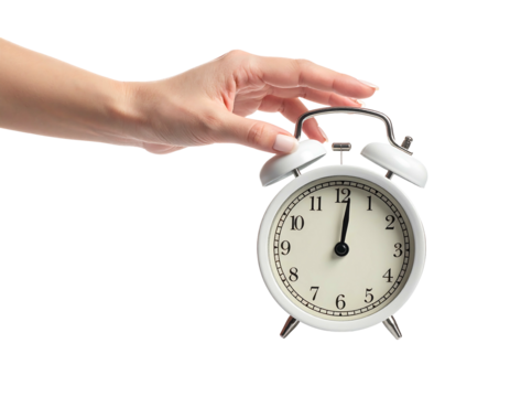 A hand reaches for a white alarm clock against a stark black background, showing the clock face at twelve o'clock