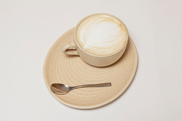  Cortado served in a small clay cup with a perfect balance between the intense espresso and warm milk.