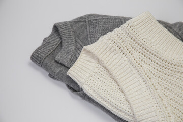 Folded Gray and White Knit Sweaters