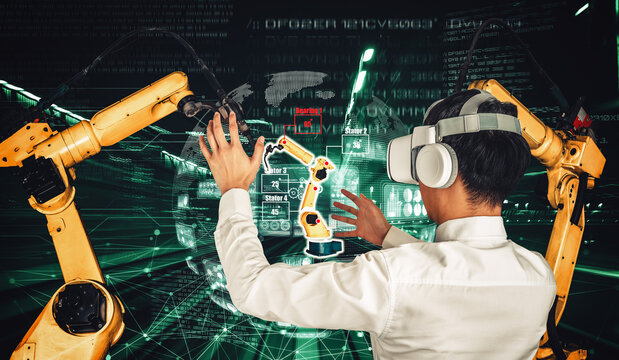 Engineer controls robotic arms by augmented reality industry technology application software. Smart robot machine in future factory working in concept of Industry 4.0 or 4th industrial revolution. - Powered by Adobe