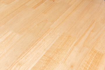 Fresh raindrops linger on the surface of treated exterior wood planks, creating a mirror effect that reflects the sky.