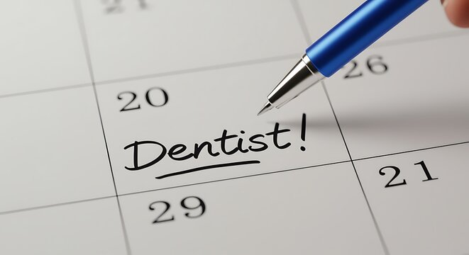 Marking Dentist Appointment on Calendar with Pen Healthcare Reminder Concept