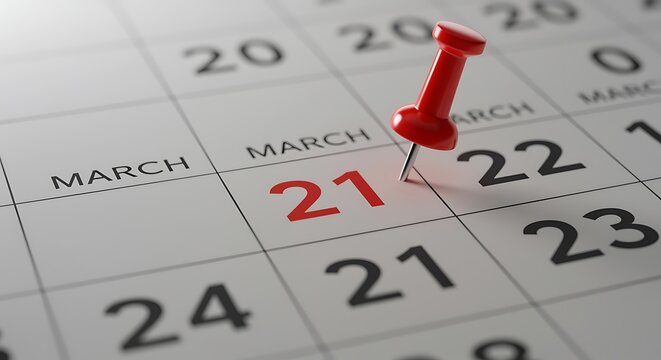 Marking March 21st on the Calendar with a Red Pushpin Closeup