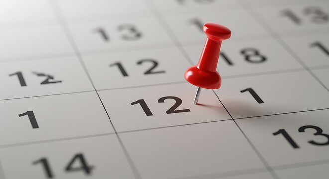 Marking twelfth day on calendar with red push pin reminder
