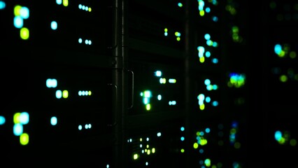 In a darkened room, rows of data servers come alive with colorful blinking lights, creating an atmosphere of advanced technology and digital connectivity as they process information rapidly.