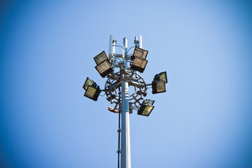 Outdoor train station lights and telecommunication tower against