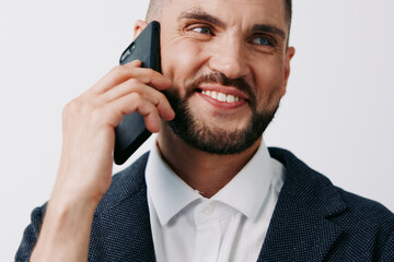 Professional man on a call, exuding confidence and approachability against a clean colored backdrop. Focused business demeanor, calm smile, and engaged expression for corporate communication.