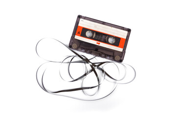 Music sound and mental health Concept. Old transparent compact. Vintage Audio cassette tape with exposed film composition unwound in mess isolated on white background.