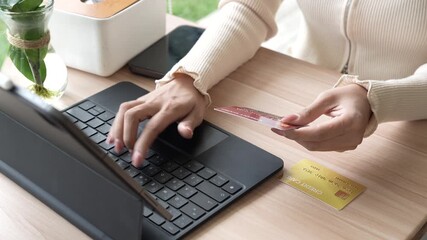 Close-up of a woman using a smartphone and holding a credit card for online shopping or payment, symbolizing digital finance and modern lifestyle. - Powered by Adobe