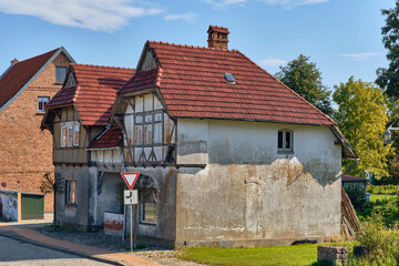 Old half-timbered house with weathered plaster and red tiled roof in Dassow, northern Germany, showing the rustic charm and aging architecture typical for small towns in the former East Germany