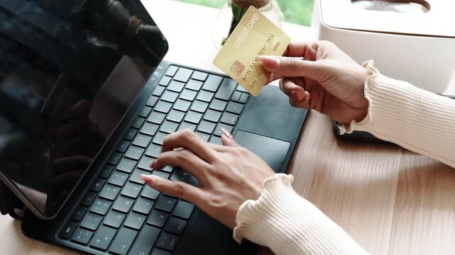 Close-up of a woman using a smartphone and holding a credit card for online shopping or payment, symbolizing digital finance and modern lifestyle.