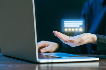 Rating and reviewing experience on a laptop during evening hours in a cozy workspace