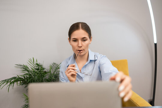 Businesswoman laptop concentration modern female entrepreneur considering data while working remotely