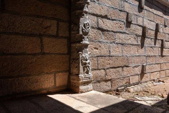Stone carvings stand in sunlight at an ancient Hindu temple in Tirunelveli, highlighting exquisite craftsmanship and spirituality.