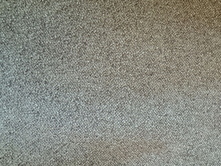 Close-up view of textured fabric with subtle gray patterns in a modern setting