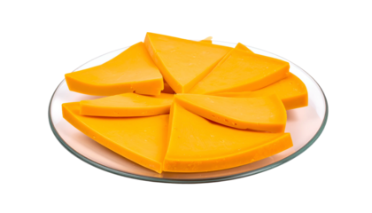 A plate holds sliced, yellow cheese arranged in a circular pattern against a black backdrop