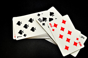 A deck of playing cards on a black background.