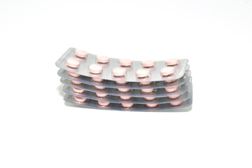 A stack of pills in a package on a white background.
