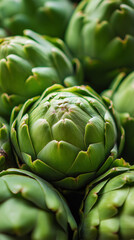 Fototapeta premium Close-up of fresh green artichokes showing natural texture and healthy organic freshness. 