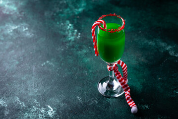 Christmas green cocktail punch with candy cane