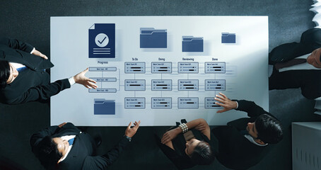Aerial view of a professional team engaged in project tracking and task management, showcasing...