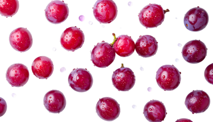 Vivid close-up of scattered, glistening red grapes with water droplets, isolated on black