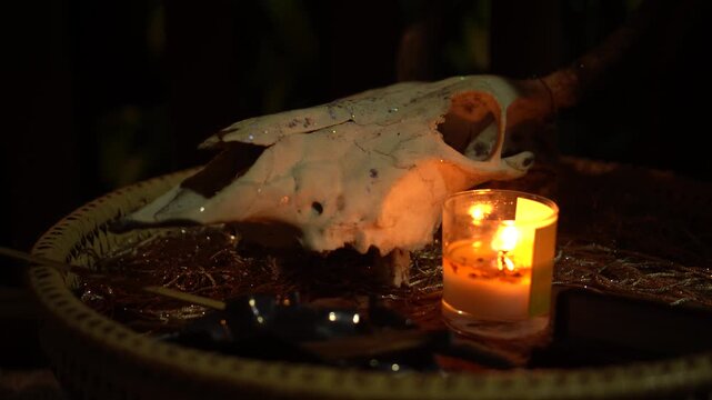 Skull of cow,candle,ancient ritual ambiance, glow surrounds mysterious artifacts