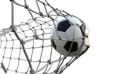 A soccer ball, with black and white panels, nestles in the netting of a goal