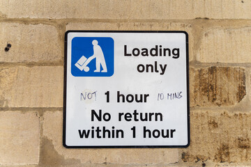 Loading only parking sign on brick wall