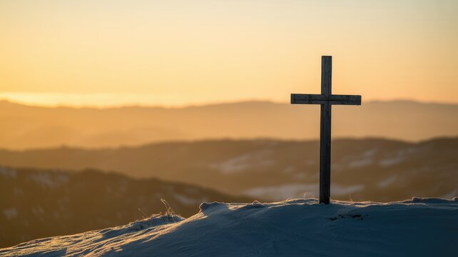 A wooden cross stands majestically on a snowy mountaintop, silhouetted against a breathtaking golden sunset, symbolizing hope and spiritual peace.