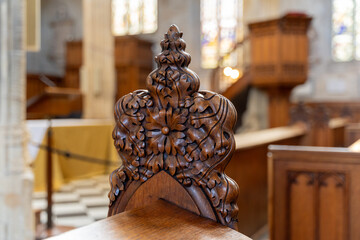 Ornate wooden church pew carving details