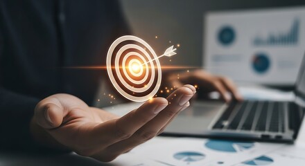 Hand holding a glowing bullseye target with an arrow hitting the center representing business success and strategic goals