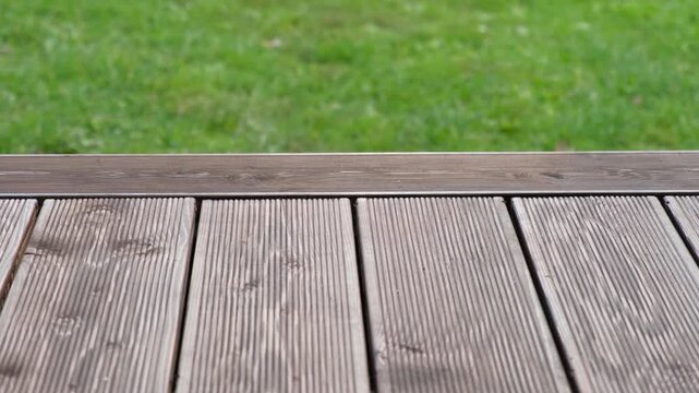 Empty rustic table top with blurred green grass landscape background. Abstract wooden counter. Mockup for promo, text or logo brand. Free space for text. Frame for display. Modern Presentation desk.