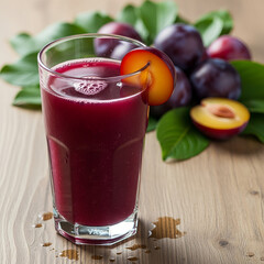 Glass of plum juice with fresh plums on wooden background
