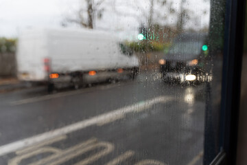 Rainy day city street view, blurred traffic