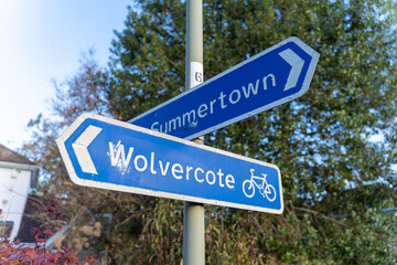 Blue signpost indicating various directions