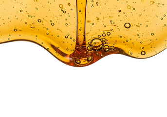 Viscous golden honey pouring and dripping with air bubbles forming a wavy line isolated on transparent background
