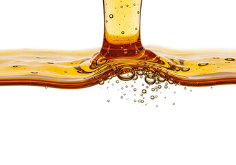 Close up of amber liquid pouring and splashing creating ripples and bubbles isolated on transparent background