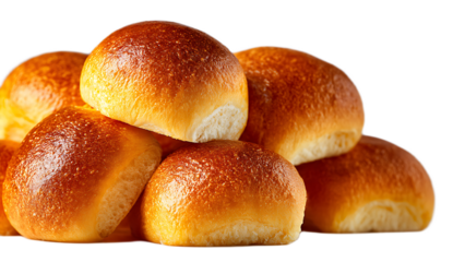 A close up view of a pile of golden brown dinner rolls against a black background in a studio shot