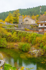 Vertical View of the Stone Church and Bell Tower of Vovousa Village, Pindos, Greece, Situated Above the Aoos River with Autumn Foliage