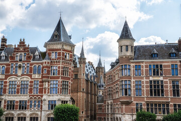 Antwerp city street showcasing historic gothic revival architecture with detailed brickwork, turrets, and intricate spires. Belgium