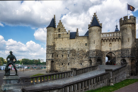 Statue De Lange Wapper in front of medieval castle Het Steen in old city center of Antwerp.