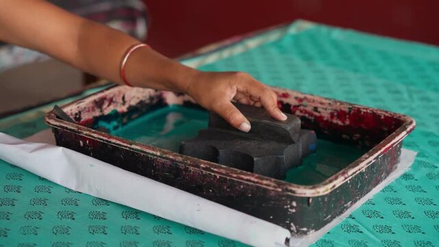 Close Shot of Hands Printing on Linen with Wooden Block in Workshop &mdash; Artisan Creating Traditional Handcrafted Textile Design, Block Printing Process, and Cultural Fabric Art in 4K Ultra HD
