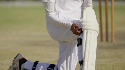 "Woman Cricketer Wearing Kneepad, Close-Up 4K Video, Sports Gear Preparation, Cricket Player Footage, Athletic Equipment and Safety Scene" - Powered by Adobe