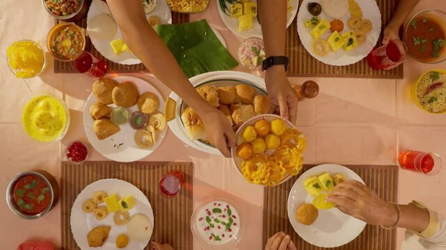 Indian Family Feast with Lunch Table Loaded with Delicious Food &mdash; Traditional Homemade Dishes, Colorful Cuisine, Family Gathering, and Cultural Celebration in Warm Natural Light 4K Ultra HD