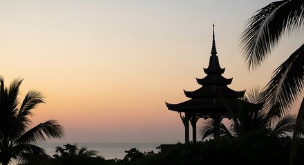 Obraz premium Silhouette of Asian pagoda and palm trees against sunset sky over ocean Asian architecture twilight