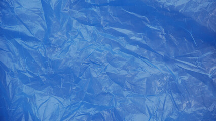 Fototapeta premium Blue plastic texture — glossy crumpled surface background