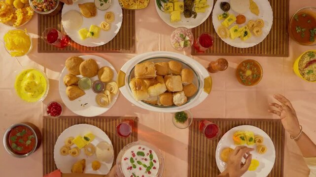 Indian Family Feast with Lunch Table Loaded with Delicious Food &mdash; Traditional Homemade Dishes, Colorful Cuisine, Family Gathering, and Cultural Celebration in Warm Natural Light 4K Ultra HD