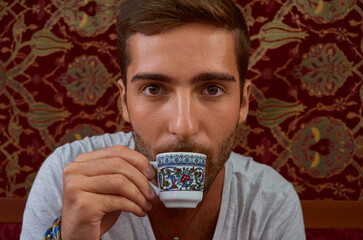 Boy drink coffee in a Istanbul coffee shop